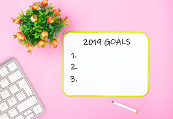new year goals check list on the modern pink office table