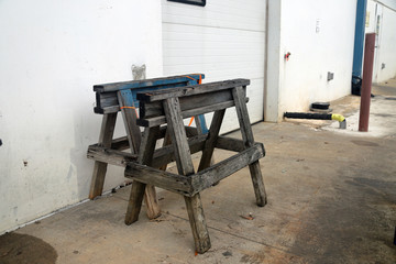 Saw Horses in front of garage door at factory