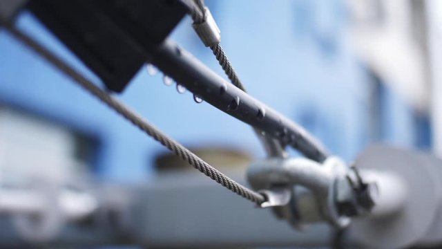 Joint hinge with a steel cable. Frame. The connection of metal staples, loops and steel ropes.