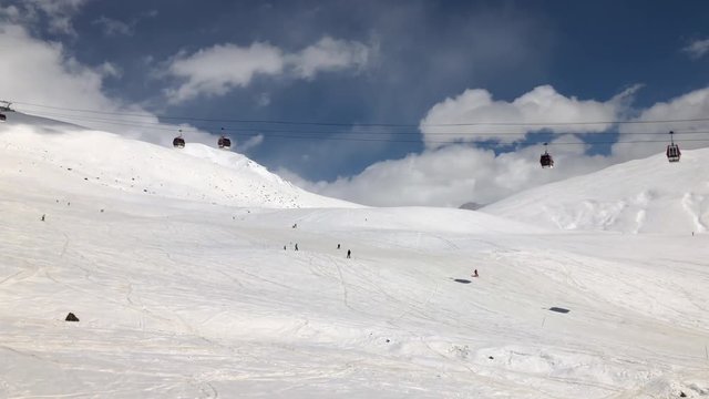 sunny day winter time gudauri ski resort lift ride slow motion panorama 4k georgia
