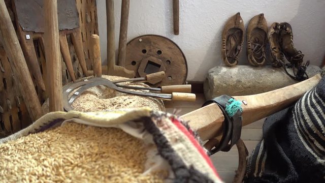 Kas, Antalya, Turkey - 18th of May, 2017: 4K In the Kas museum of ethnography - Sack of wheat and old leather bast shoes
