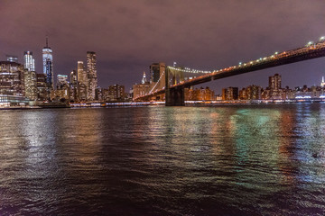 Downtown Financial District and Brooklyn Bridge Along New York City's East River at Night