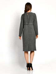 Young beautiful woman posing in new dark green gray fashion winter dress backside rear view