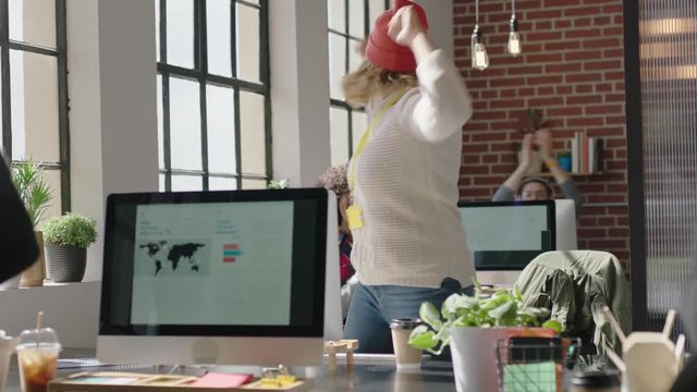 happy caucasian business woman celebrating success enjoying victory jumping excited colleagues clapping arms raised showing support cheerful enthusiastic teamwork in diverse office 