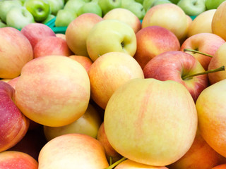 Many red and green apples stretching into the distance as a background