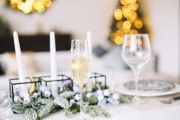 A glass of champagne. Serving a festive table. New year decorations. Christmas and  New Year concept