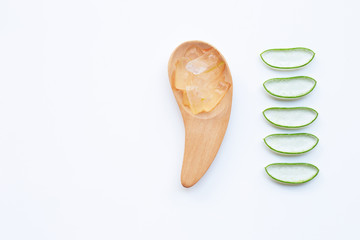 Slices of Aloe Vera and aloe vera gel on wooden spoon. isolated on white