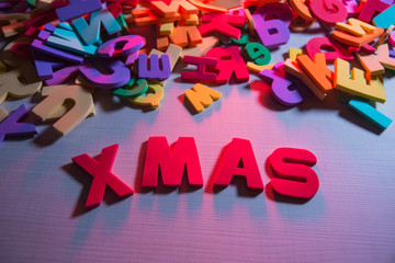 Fototapeta premium Children's word on wooden table: XMAS