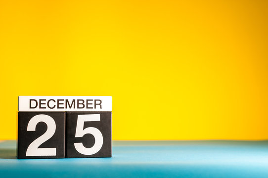 December 25th. Image 25 day of december month, calendar at yellow background. Christmas and new year celebration. Mockup