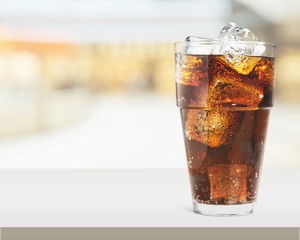 Glass of cola with ice cubes isolated on white background