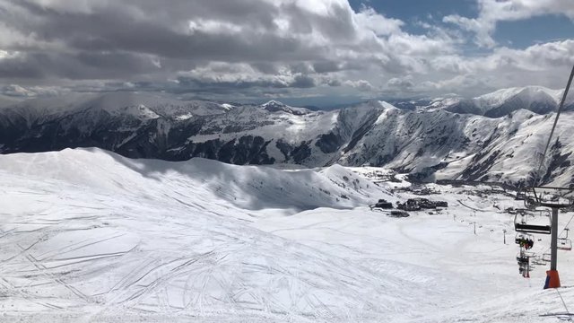 sunny day winter time gudauri ski resort lift ride slow motion panorama 4k georgia
