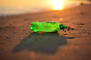 Plastic garbage, Dirty waste on beach in summer day. on the sunset.
