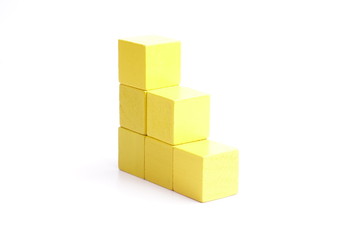 Obraz premium Yellow wooden blocks on white background.