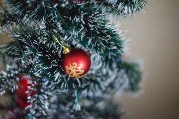 Red ball with golden on christmas tree