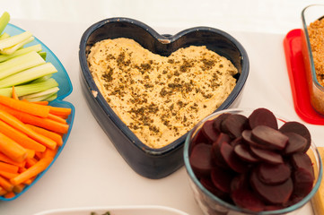 heart shaped dish of hummus