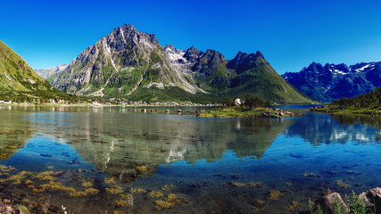 The landscape of Norway in the summer. View of Laupstadosen is a bay near Austvagoya Island, the northeasternmost of the larger islands in the Lofoten archipelago in Norway.