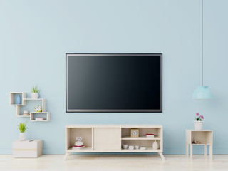 Fototapeta na wymiar TV on the cabinet in modern living room on blue wall background,3D rendering
