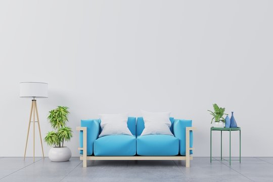 Modern living room interior with blue sofa and green plants,lamp,table on white wall background. 3d rendering.