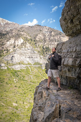 Hiker Standing on Edge of Cliff