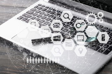 Laptop computer with magnifying glass.