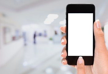 Hand holding smartphone  on blurred city background, bokeh