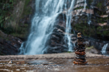 Fototapeta na wymiar stacked stones in waterfall