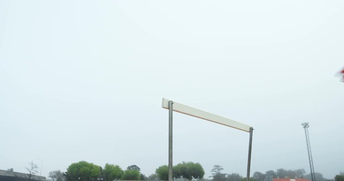 Female athlete jumping over hurdles on a running track 4k