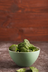 Fresh green vegetables in a bowl and on the table