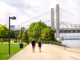 People walk on a path along urban Waterfront Park in Louisville Kentucky