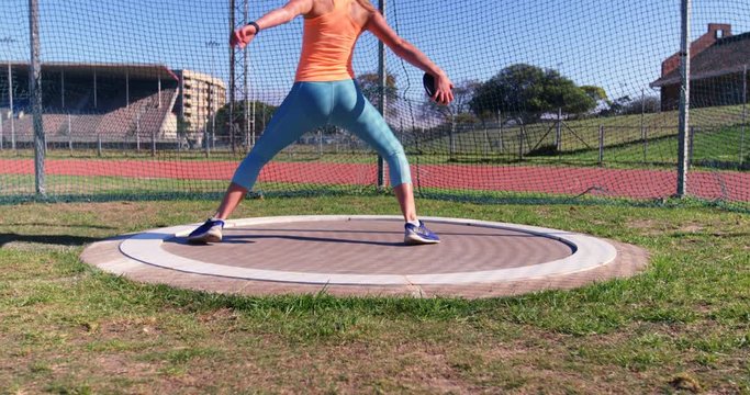 Female athlete practicing discus throw 4k