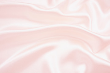 The texture of the satin fabric of pink color for the background