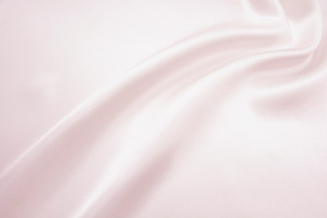 The texture of the satin fabric of pink color for the background