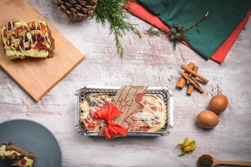 Christmas Cake packed over wooden white table with ingredientes