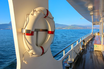 red and white safety torus or lifebuoy hanging on the boat