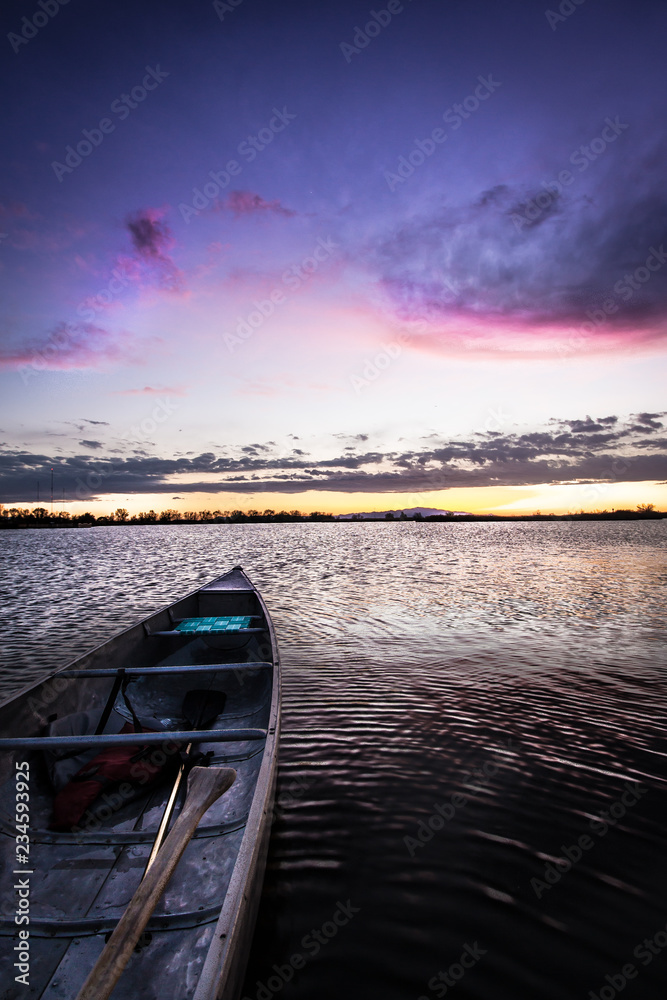 Wall mural Canoe on a Lake at Sunset