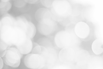Abstract glamorous white and silver bokeh lights glitter sparkle. Defocused background have luxury golden color party invite for birthday, anniversary, holliday, new year xmas or snow christmas blur.