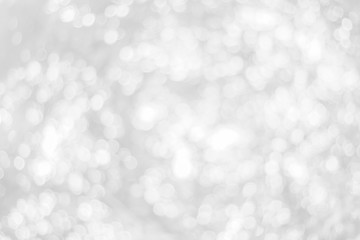 Abstract glamorous white and silver bokeh lights glitter sparkle. Defocused background have luxury golden color party invite for birthday, anniversary, holliday, new year xmas or snow christmas blur.