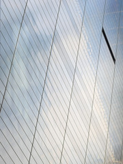 Fototapeta na wymiar Modern generic glass office building exterior, dutch angle