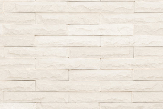 Seamless Grey pattern of decorative brick sandstone wall surface with concrete of modern style design decorative uneven have cracked realmasonry wall of multicolored stones or blocks with cement.