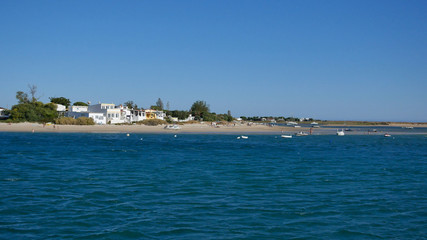 Beautiful Armona Island beach, Algarve, Portugal. Seen from a boat on the sea, in summer on a sunny day with blue sky.