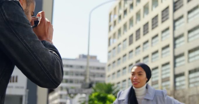 Man taking photo of woman with digital camera 4k