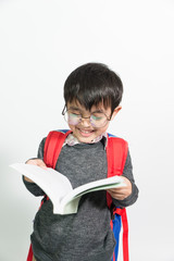 Asian little boy kid  reading the book for knowledge . Isolated over white background.  clever kid and intelligence concept