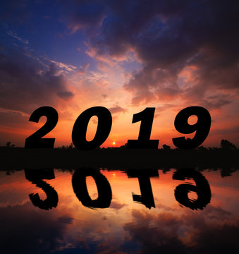 Silhouette and reflection in water sunset background.number 2019. Photo Silhouette and new year  concept idea.