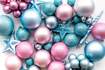 Christmas and New Year symbols. Toys for festive tree. Blue and pink balls and stars on white background top view