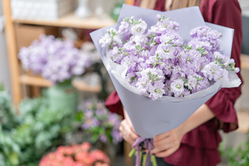 European floral shop. Two Bouquet of beautiful lilac flowers in woman hand. Excellent garden flowers in the arrangement , the work of a professional florist.