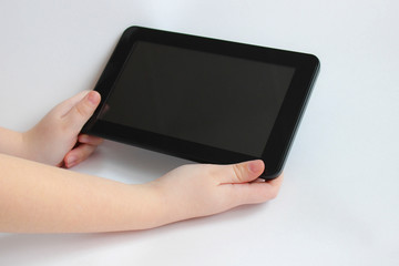 The child is holding a tablet computer