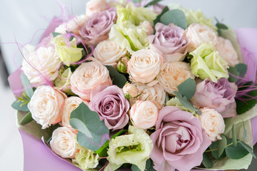 Bouquet of fresh spring flowers on gray wall background. Floral bunch in glass vase. flower shop, florist work