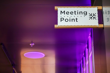 Meeting point sign at the tourist in a modern hall ,Meeting place for lost people or a safe point in an emergency.