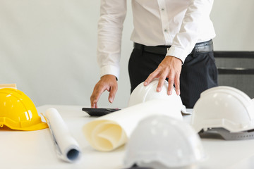 Safety helmet on table in office , engineer concept Teamwork of building construction