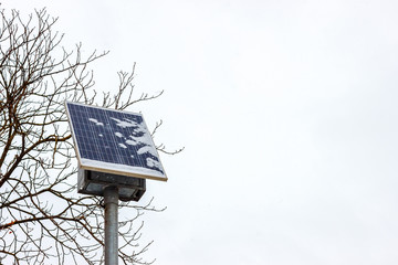 The snow-covered photovoltaic solar panel at the winter blizzard time. The problem of the solar power generation in north countries concept